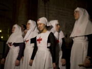 Christian nuns watch as a team of experts begin the renovation of Jesus&#039; tomb in the Church of the Holy Sepulchre in Jerusalem&#039;s old city, Monday, June 6, 2016. A team of experts has begun a historic renovation at the spot where Christians believe Jesus was buried, overcoming longstanding religious rivalries to carry out the first repairs at the site in over 200 years.