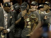 Cleveland Cavaliers forward LeBron James, center, celebrates with teammates after Game 7 of basketball&#039;s NBA Finals against the Golden State Warriors in Oakland, Calif., Sunday, June 19, 2016. The Cavaliers won 93-89.