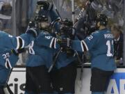 San Jose Sharks right winger Joonas Donskoi, center, celebrates with teammates after scoring the winning goal during overtime of Game 3 of the Stanley Cup Final against the Pittsburgh Penguins in San Jose, Calif., Saturday, June 4, 2016. The Sharks won 3-2.