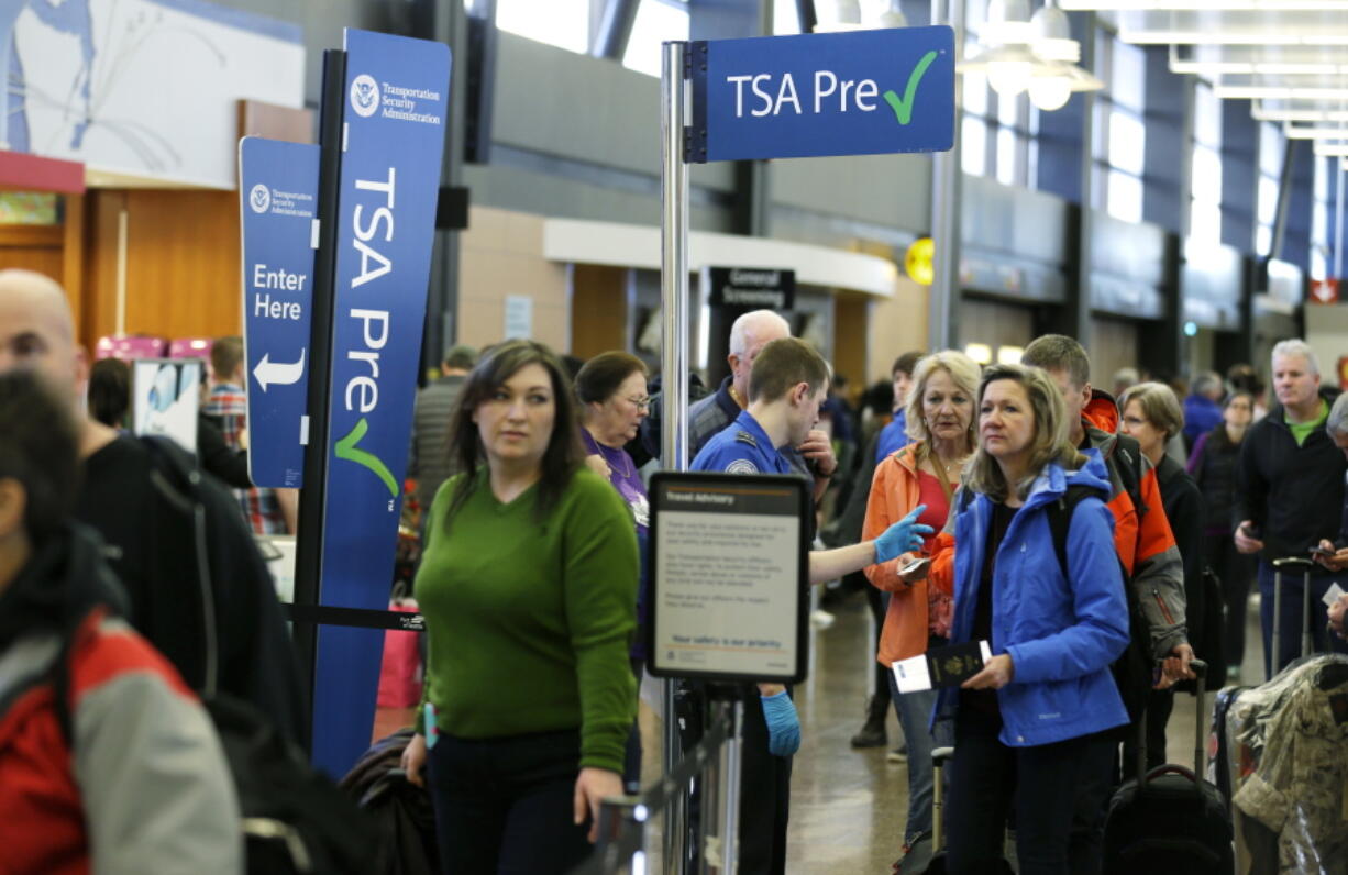 Travelers authorized to use the Transportation Security Administration&#039;s PreCheck expedited security line at Seattle-Tacoma International Airport in Seattle have their documents checked by TSA workers March 17. Thousands of fliers enrolled in trusted traveler programs such as PreCheck aren&#039;t getting the expedited screening they paid for because of clerical errors with their reservations. (AP Photo/Ted S.