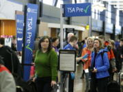 Travelers authorized to use the Transportation Security Administration&#039;s PreCheck expedited security line at Seattle-Tacoma International Airport in Seattle have their documents checked by TSA workers March 17. Thousands of fliers enrolled in trusted traveler programs such as PreCheck aren&#039;t getting the expedited screening they paid for because of clerical errors with their reservations. (AP Photo/Ted S.