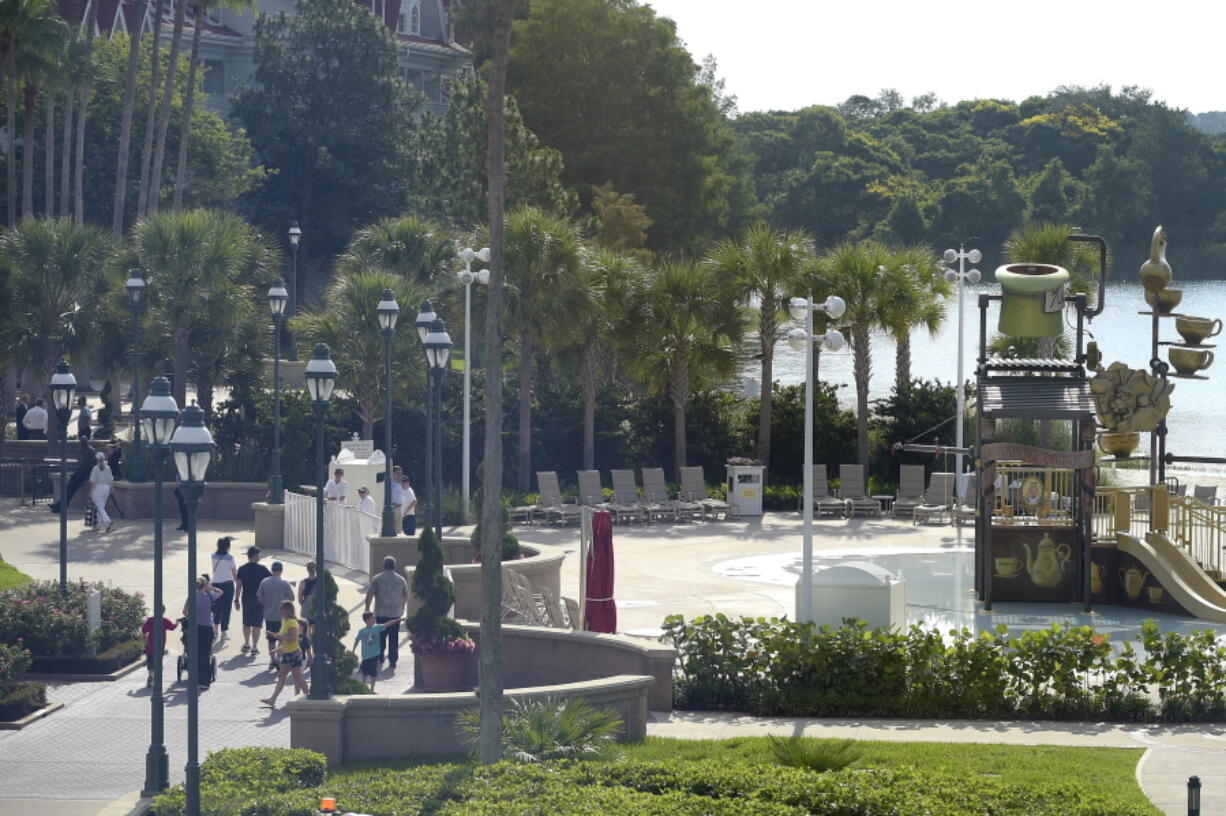 Hotel guests are directed away from the closed pool and beach area as law enforcement officials search the Seven Seas Lagoon outside the Grand Floridian Resort &amp; Spa on Wednesday in Lake Buena Vista, Fla., after a two-year-old toddler was dragged into the lake by an alligator. (AP Photo/Phelan M.