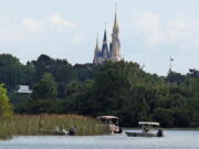 In the shadow of the Magic Kingdom, authorities search on June 15 for the body of a boy who was dragged away by an alligator at Grand Floridian Resort at Disney World in Lake Buena Vista, Fla.