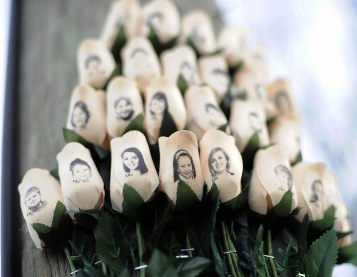 White roses with the faces of victims of the Sandy Hook Elementary School shooting are attached to a telephone pole near the school in Newtown, Conn., in 2013. The deadliest shooting in U.S. history has people around the world wondering why mass violence keeps happening in America. For those who have lived through mass shootings, and for the law enforcement officers trying to prevent them, the answer is self-evident. ?Because we allow it,? said Sandy Phillips, whose daughter was among 12 killed at Colorado movie theater in July 2012.