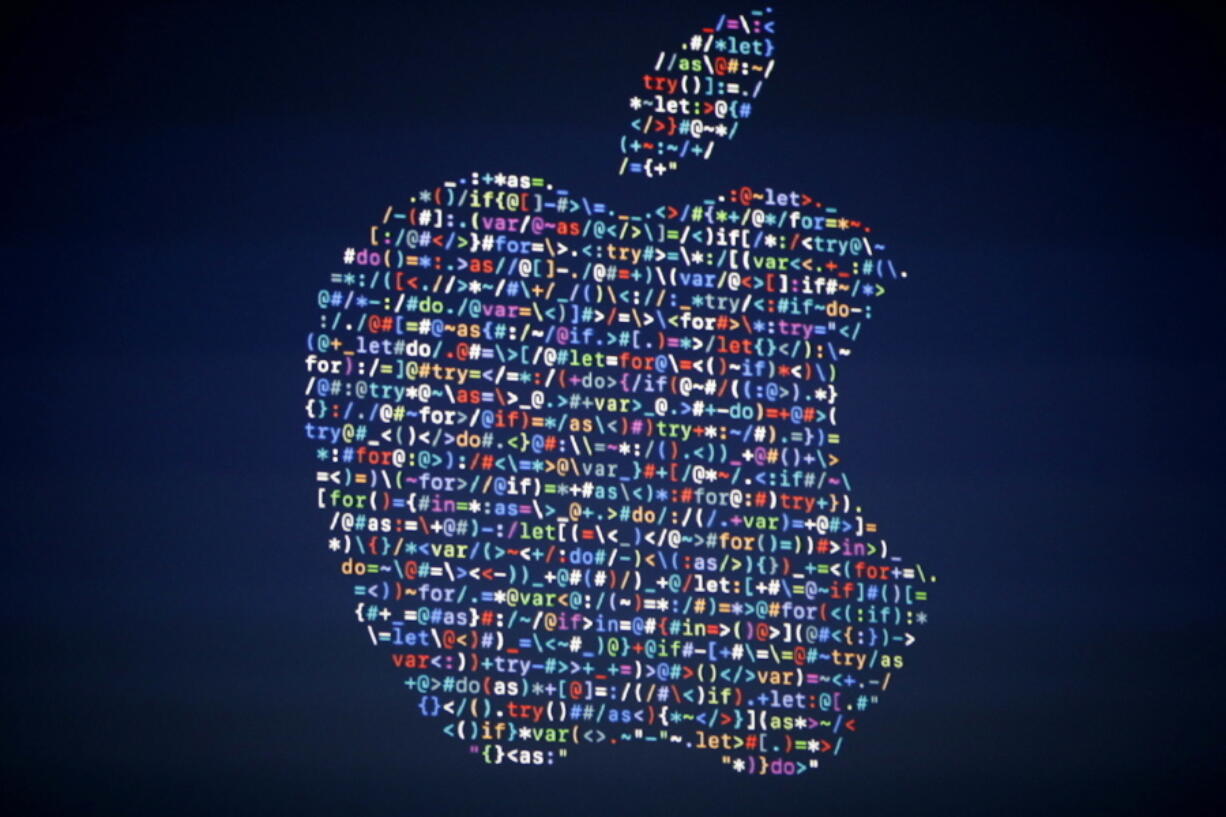 The Apple logo is shown on a screen at the Apple Worldwide Developers Conference in the Bill Graham Civic Auditorium in San Francisco on Monday.