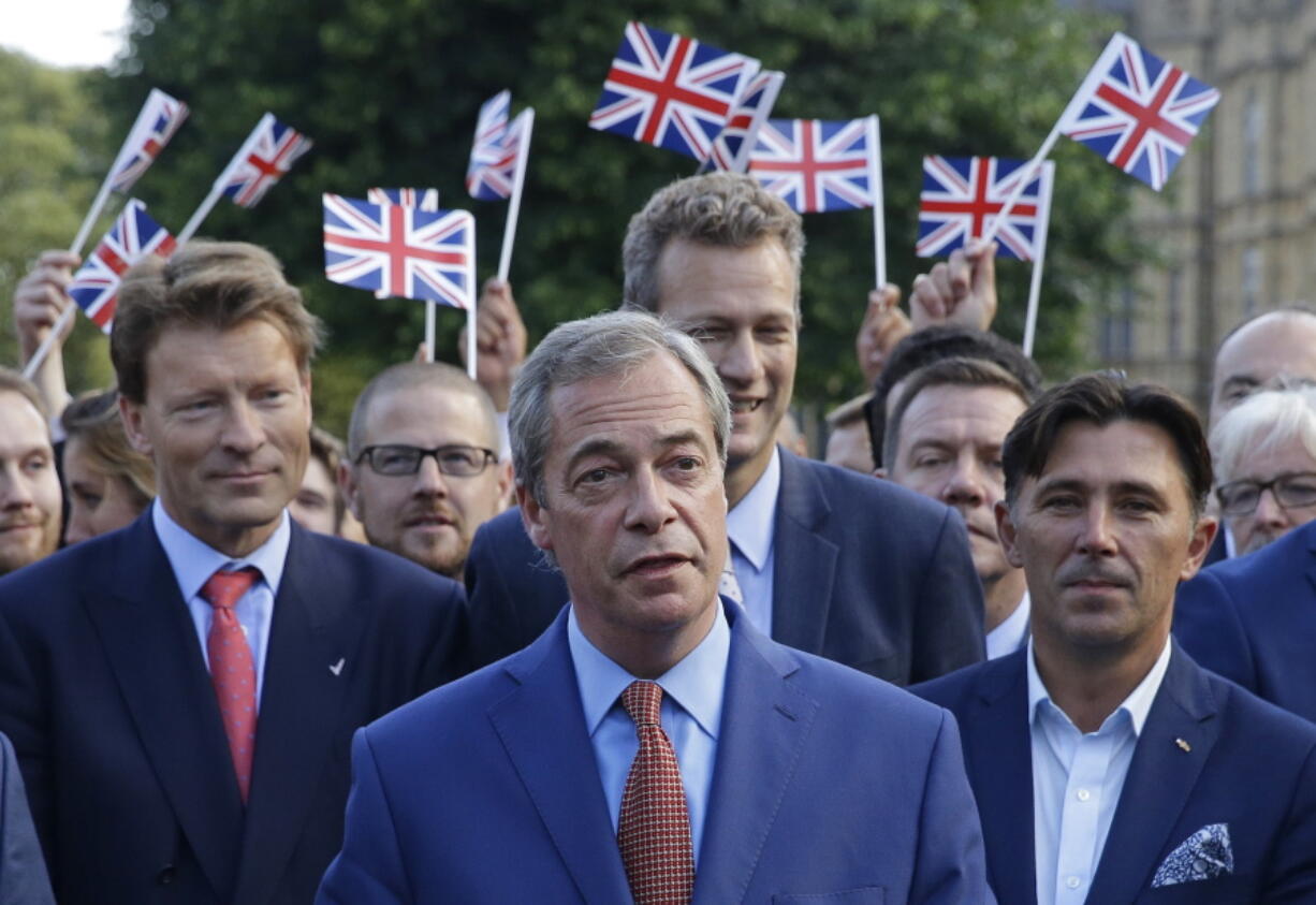 Nigel Farage, the leader of the UK Independence Party speaks to the media Friday on College Green in London.