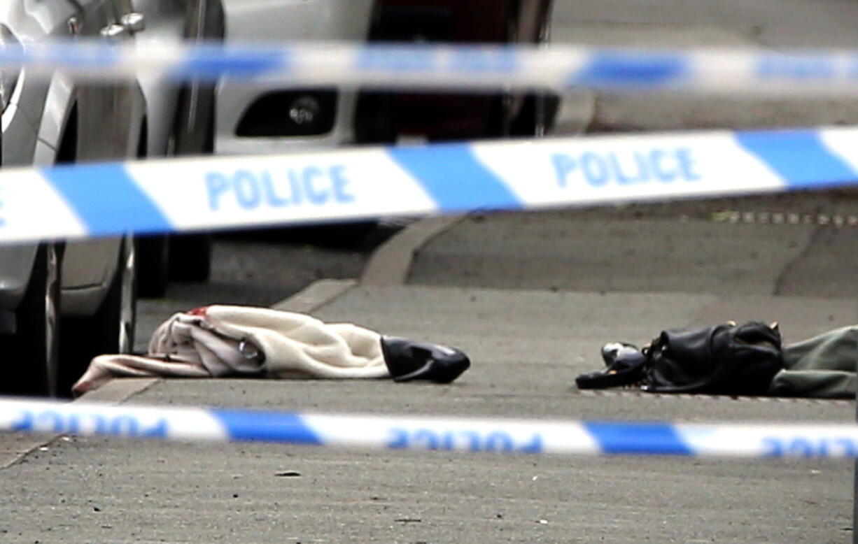 Items on the ground at the scene after Labour Member of Parilament Jo Cox was shot and injured in an attack, in Birstall, West Yorkshire, England, on Thursday. Both sides in the British referendum debate Thursday suspended campaigning after Labour lawmaker Jo Cox was seriously injured in a shooting near Leeds.