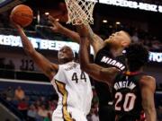 New Orleans' Dante Cunningham shoots over Miami's Chris Andersen.