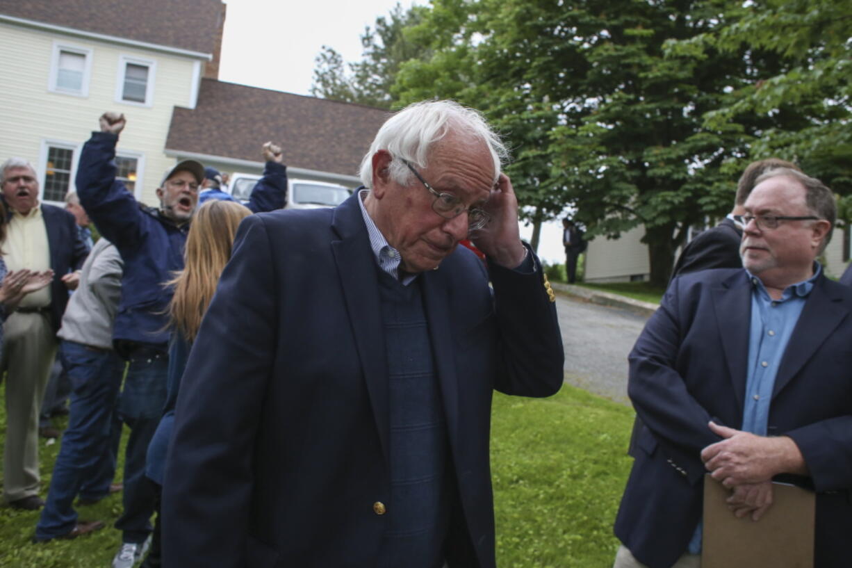 Democratic presidential candidate, Sen. Bernie Sanders, I-Vt., walks away after speaking at a news conference outside his home Sunday in Burlington, Vt.