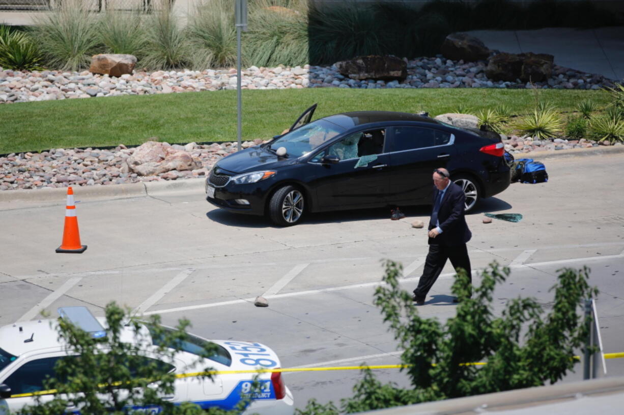 An investigator works the scene of an officer-involved shooting that prompted a lockdown at Dallas Love Field airport Friday.