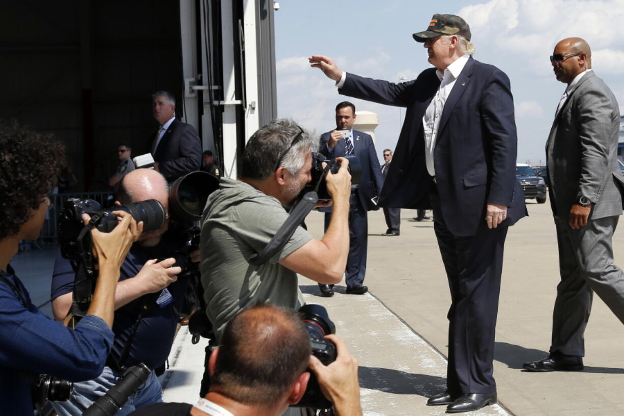 Republican presidential candidate Donald Trump waves to the crowd as he is photographed arriving to speak at a campaign rally, Saturday at a private hanger at Greater Pittsburgh International Airport in Moon, Pa.