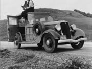 This 1936 image shows Resettlement Administration photographer Dorothea Lange sitting atop a vehicle in California. Lange is among the women whose stories are featured as part of The Women on the Mother Road project, a partnership between Cinefemme and the National Park Service to highlight women&#039;s experiences along historic Route 66.