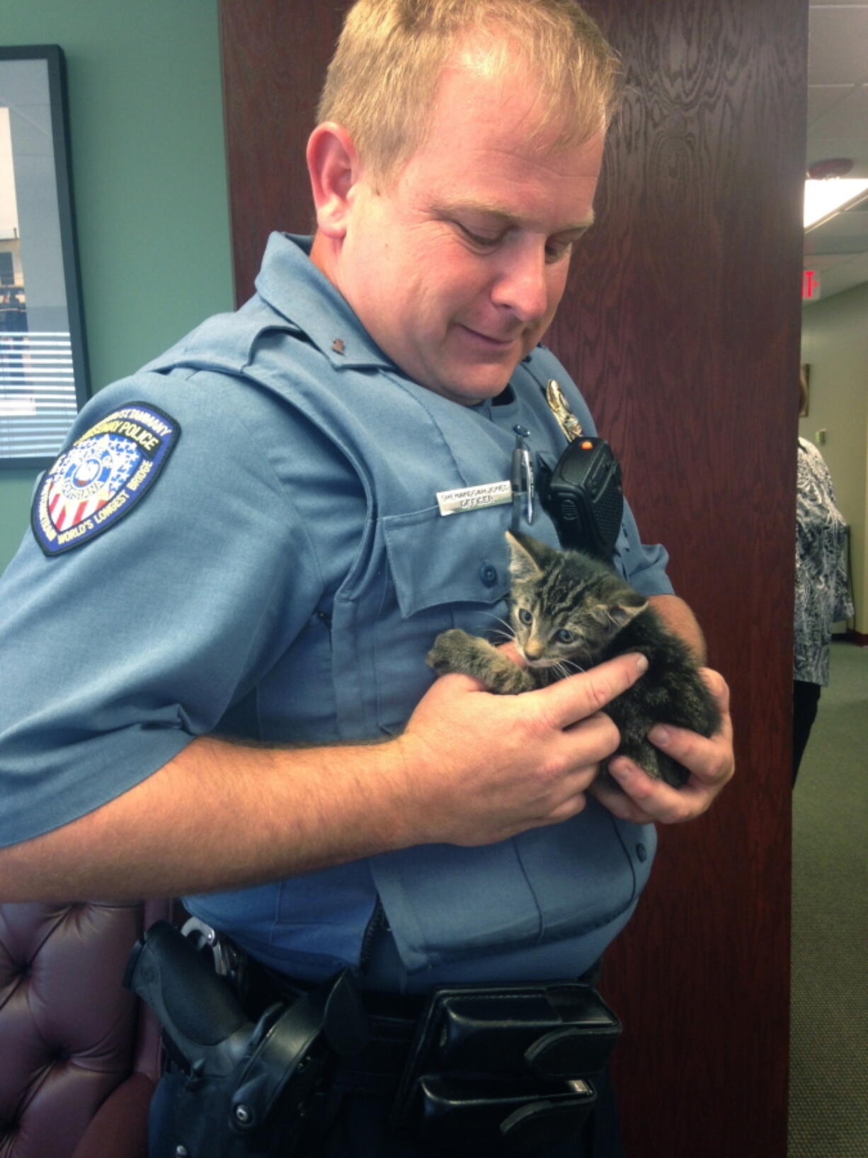 Officer Shenandoah Jones holds a kitten that was found Tuesday on the Lake Pontchartrain Causeway Bridge about a half-mile out on the northbound span from Metairie.