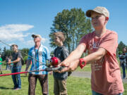 Charlie Smith, a fifth-grader at Laurin Middle School, practices casting fishing lures in an after-school fishing lesson with teacher Darrell Kirkpatrick.