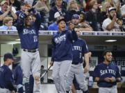 Seattle Mariners' Robinson Cano, Leonys Martin, Seth Smith, and Nelson Cruz, from left,  celebrate during the seventh inning against the San Diego Padres in a baseball game Thursday, June 2, 2016, in San Diego. The Mariners scored nine runs in the inning.