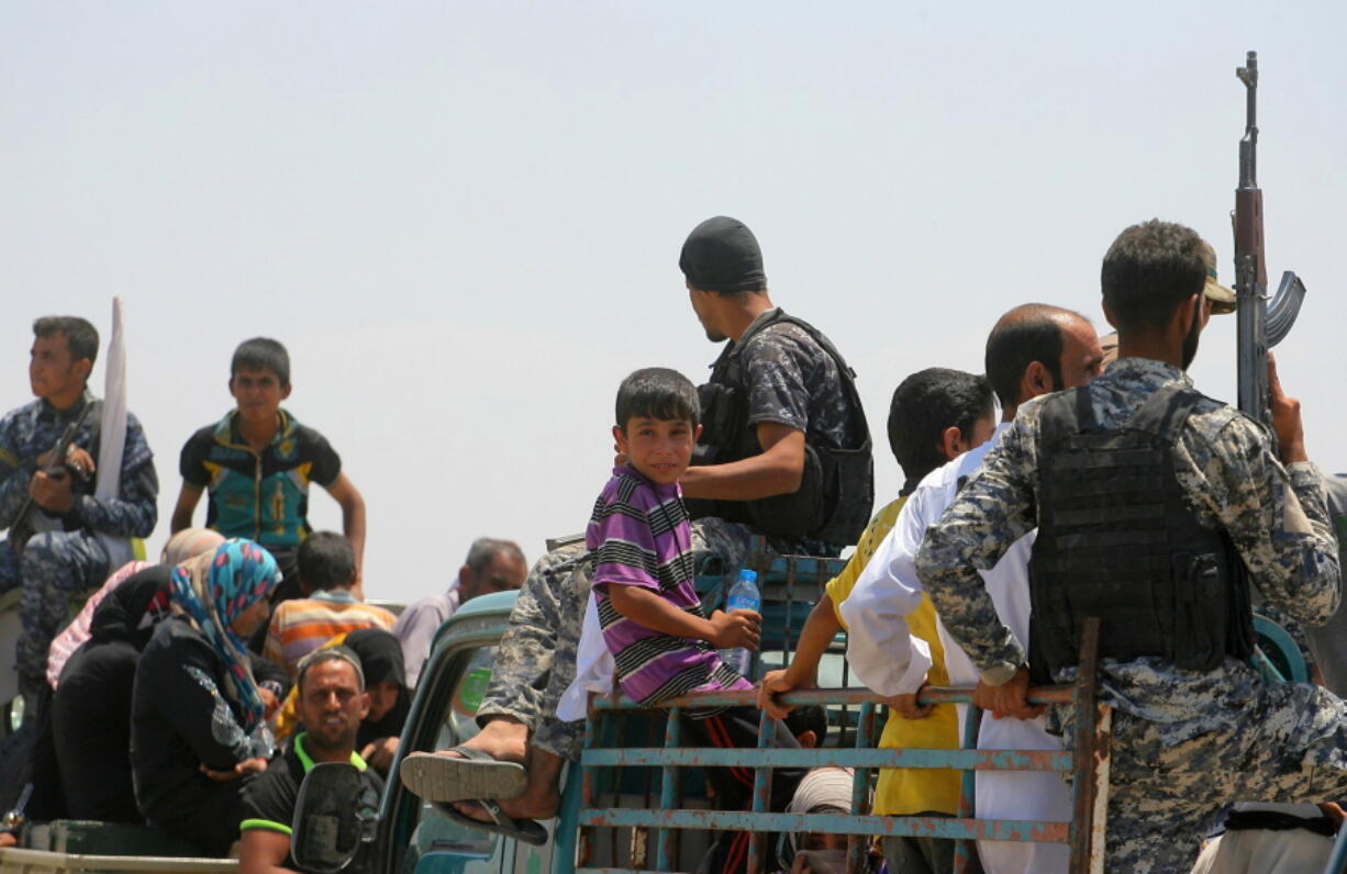 Families from Fallujah flee their homes during fighting between Iraqi security forces and Islamic State group during a military operation to regain control the city, west of Baghdad, Iraq, on Wednesday. The U.N.