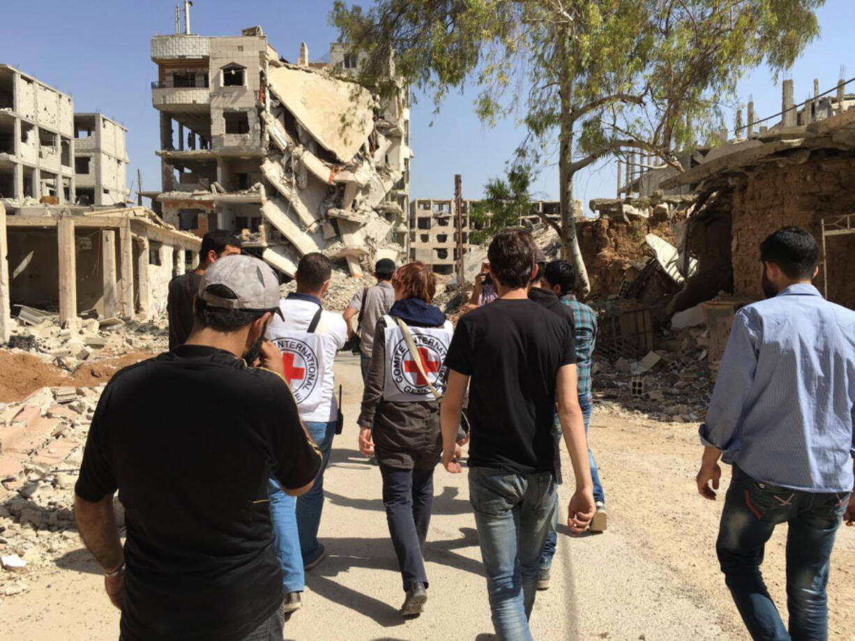 This image released by the International Committee for the Red Cross shows the first humanitarian aid convoy in Daraya, Syria on Wednesday, June 1, 2016. A besieged suburb of Syria&#039;s capital received humanitarian aid Wednesday for the first time since 2012, as the United Nations. The International Committee for the Red Cross (ICRC) reported that a joint convoy with the U.N. and the Syrian Arab Red Crescent entered the Damascus suburb of Daraya in the afternoon. The U.N.