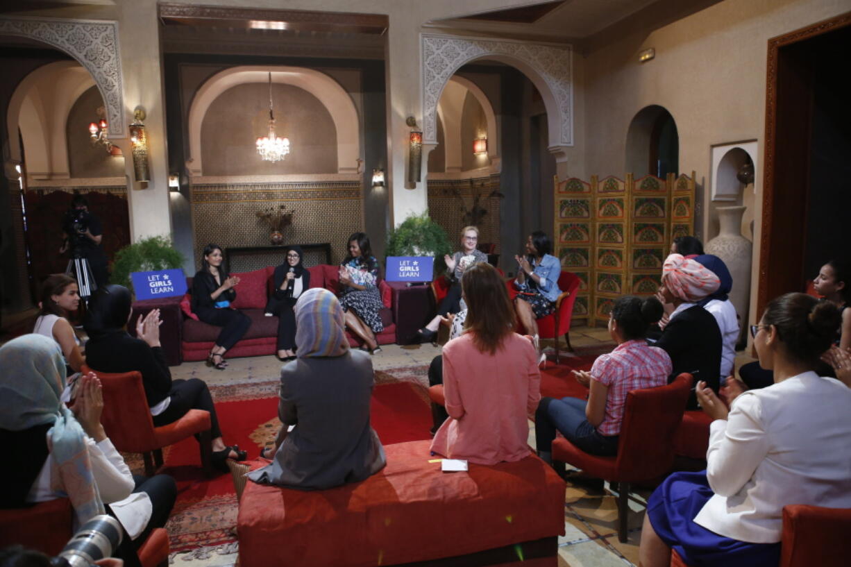 U.S. first lady Michelle Obama, behind center, actress and advocate for girls&#039; education Meryl Streep, second right,+and Indian actress Freida Pinto, left on sofa, participate in a conversation with adolescent girls in Marrakech, Morocco on Tuesday.