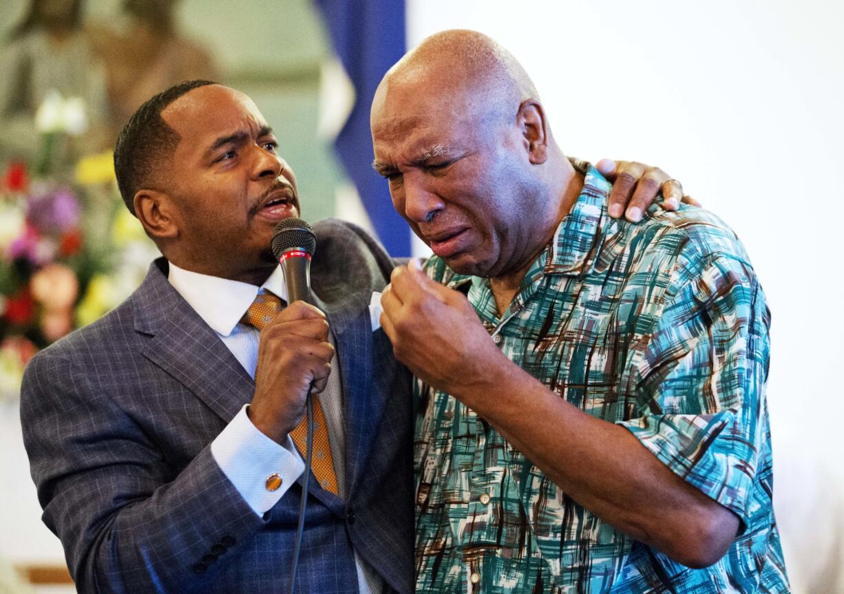 Rahaman Ali, brother of Muhammad Ali, right, cries while embraced by assistant pastor Rev. Charles Elliott, III., during a service at King Solomon Missionary Baptist Church where Muhammad Ali's father worshipped and where Muhammad Ali would occasionally accompany him, Sunday, June 5, 2016, in Louisville, Ky. Muhammad Ali, the magnificent heavyweight champion whose fast fists and irrepressible personality transcended sports and captivated the world, died Friday at the age of 74.