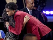 Marquese Chriss hugs a supporter after being selected eighth overall by the Sacramento Kings during the NBA basketball draft, Thursday, June 23, 2016, in New York.