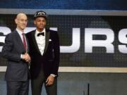 Dejounte Murray poses for a photo with NBA Commissioner Adam Silver after being selected 29th overall by the San Antonio Spurs during the NBA basketball draft, Thursday, June 23, 2016, in New York.