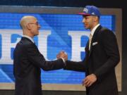 NBA Commissioner Adam Silver, left, greets Ben Simmons after announcing him as the top pick by the Philadelphia 76ers during the NBA basketball draft, Thursday, June 23, 2016, in New York.