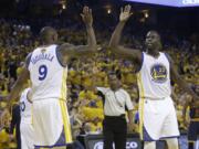 Golden State Warriors forward Draymond Green (23) and forward Andre Iguodala (9) celebrate during the first half of Game 2 of basketball's NBA Finals between the Warriors and the Cleveland Cavaliers in Oakland, Calif., Sunday, June 5, 2016.