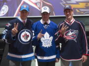 The NHL top three draft picks, Patrik Laine, Winnipeg Jets; Auston Matthews, Toronto Maple Leafs; and Pierre-Luc Dubois, Columbus Blue Jackets, pose for a photo at the NHL hockey draft, Friday, June 24, 2016, in Buffalo, N.Y.