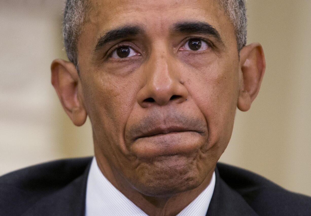 President Barack Obama pauses while speaking to members of the media in the Oval Office of the White House in Washington on Monday after getting briefed on the investigation of a shooting at a nightclub in Orlando by FBI Director James Comey, Homeland Security Secretary Jeh Johnson, and other officials.