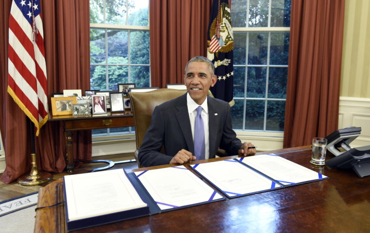 President Barack Obama smiles Thursday as he waits for the press to arrive before signing the FOIA Improvement Act of 2016 and the Puerto Rico rescue package in Washington.