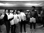 FILE - In this Feb. 18, 1964, file photo, the Beatles, from left, Paul McCartney, John Lennon, Ringo Starr, and George Harrison, take a fake blow from Cassius Clay (Muhammad Ali) while visiting the heavyweight contender at his training camp in Miami Beach, Fla.  Ali, the magnificent heavyweight champion whose fast fists and irrepressible personality transcended sports and captivated the world, has died according to a statement released by his family Friday, June 3, 2016. He was 74.