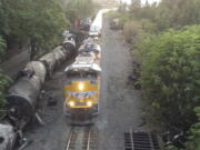 Crumpled oil tankers lying beside the railroad tracks after a fiery train derailment on June 3  that prompted evacuations from the tiny Columbia River Gorge town about 70 miles east of Portland in Mosier, Ore. Union Pacific said Wednesday that it will resume running oil trains through the Gorge.