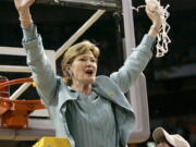 FILE - In this April 8, 2008, file photo, Tennessee coach Pat Summitt holds up the net as her son, Tyler, looks on after Tennessee beat Stanford 64-48 to win its eighth national women&#039;s basketball championship, at the NCAA women&#039;s basketball tournament Final Four in Tampa, Fla.  Summitt, the winningest coach in Division I college basketball history who uplifted the women&#039;s game from obscurity to national prominence during her career at Tennessee, died Tuesday morning, June 28, 2016. She was 64.