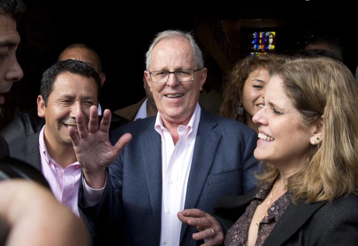 Presidential candidate Pedro Pablo Kuczynski, center, shown Tuesday with one of his two running mates, Mercedes Araoz, right, has a razor-thin lead over his rival Keiko Fujimori.