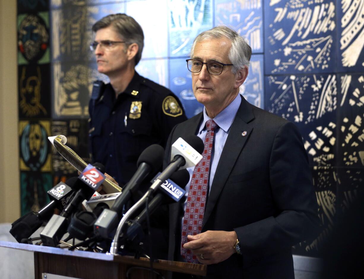 Portland Mayor Charlie Hales pauses as a protester yells and plays a recording on a megaphone during a press conference in Portland, Ore., Monday, June 27, 2016. Hales announced that Portland Police Chief Larry O'Dea, who has been on leave since revelations he may have lied about accidentally shooting a friend in the back during an April hunting trip in Eastern Oregon, has retired. Portland Police Capt. Michael Marshman, who Hales named as O'Dea's successor, stands at left. Hales cut the press conference short and walked out because of noisy protestors.