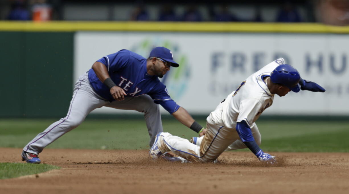 Texas Rangers shortstop Elvis Andrus, left, tags Seattle Mariners&#039; Ketel Marte out on a steal-attempt during the first inning of a baseball game Sunday, June 12, 2016, in Seattle.