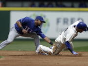 Texas Rangers shortstop Elvis Andrus, left, tags Seattle Mariners&#039; Ketel Marte out on a steal-attempt during the first inning of a baseball game Sunday, June 12, 2016, in Seattle.