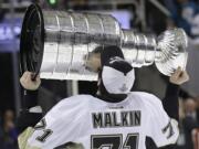 Pittsburgh Penguins center Evgeni Malkin (71), from Russia, kisses the Stanley Cup after Game 6 of the NHL hockey Stanley Cup Finals between the San Jose Sharks and the Penguins in San Jose, Calif., Sunday, June 12, 2016. The Penguins won 3-1 to win the series 4-2.