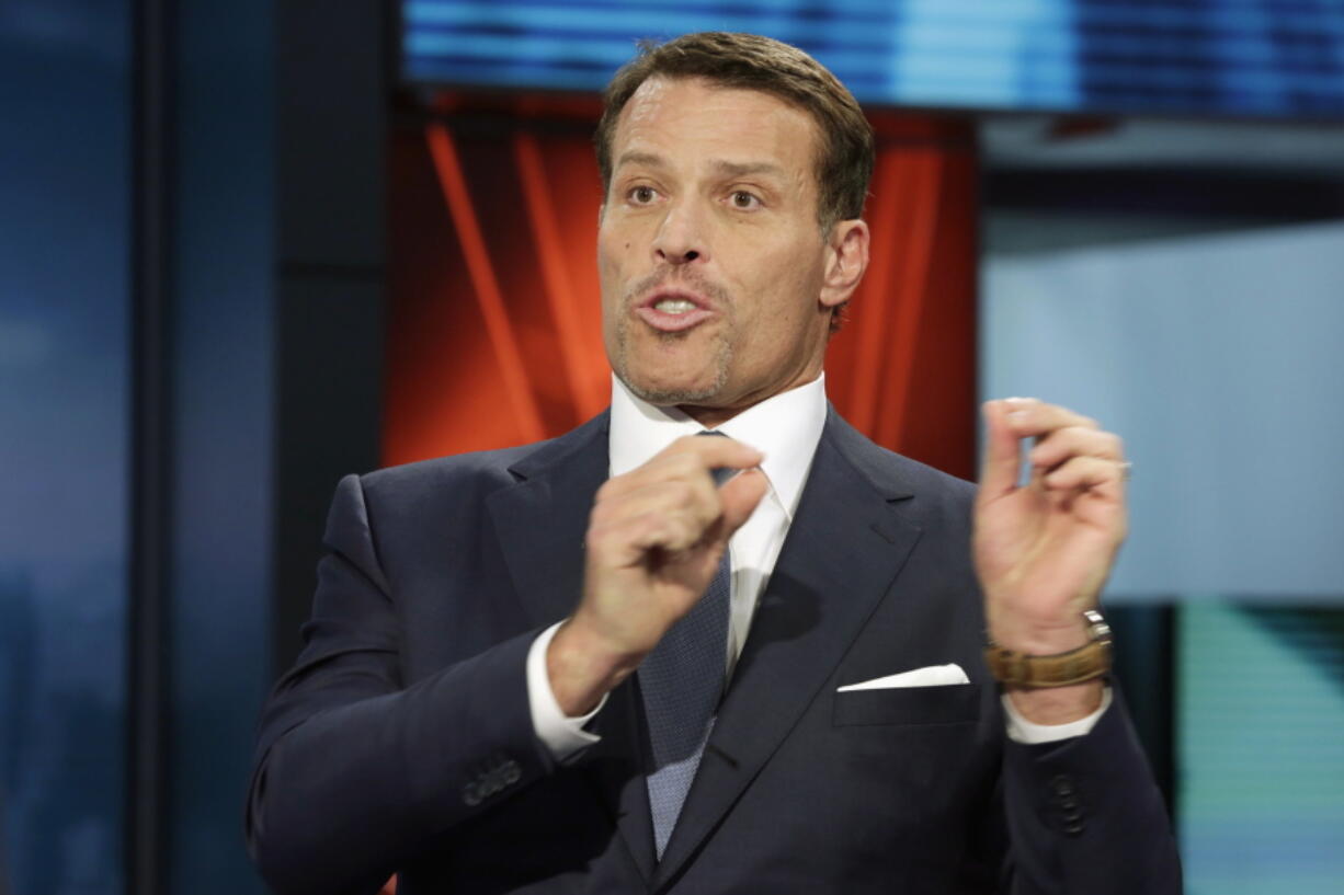 Motivational speaker Tony Robbins is interviewed March 17 during a taping of &quot;Wall Street Week,&quot; on the Fox Business Network in New York. Fire officials say more than 30 people attending a Tony Robbins event Thursday in Dallas have been treated for burns after the motivational speaker encouraged them to walk on hot coals.