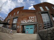 In this photograph taken with a fisheye lens, a pair of children head for the entrance of The Source, a restaurant and food shop complex along Brighton Boulevard in Denver.