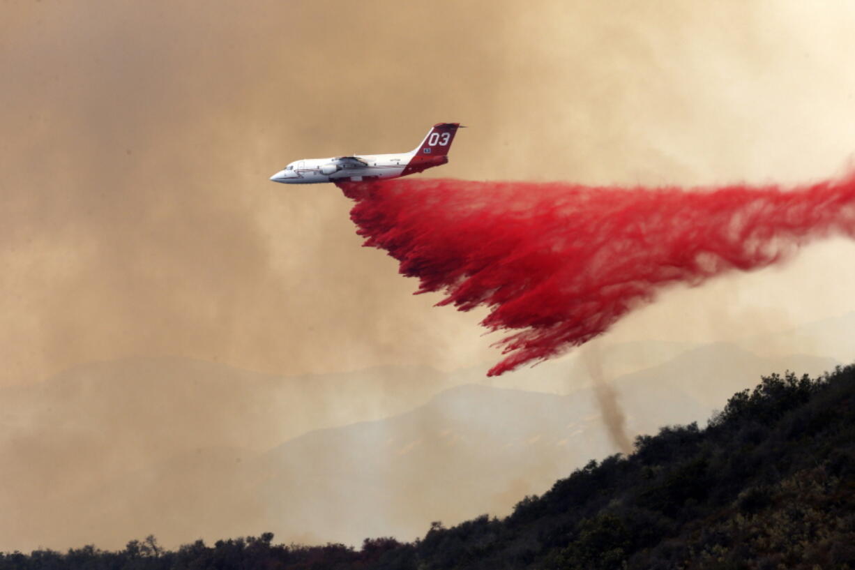 A DC-10 tanker drops fire retardant at a low altitude to help combat a wildfire near Santa Barbara, Calif., on Friday, June 17, 2016.