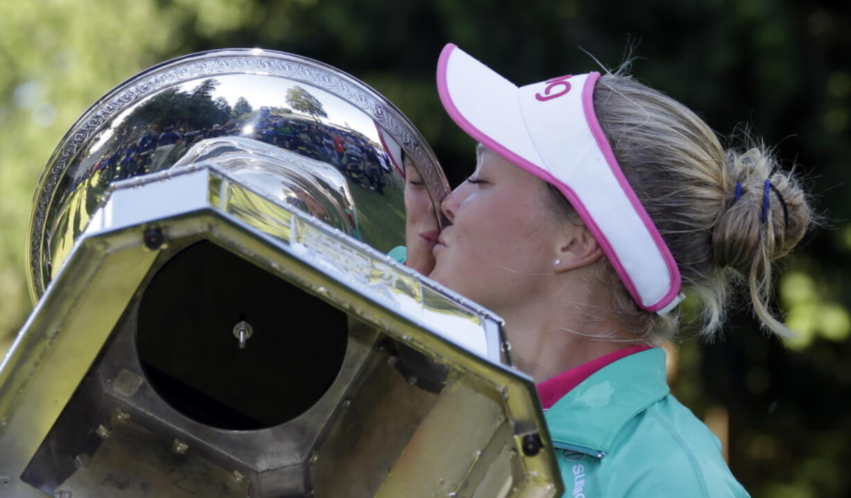 Brooke Henderson plants a kiss on the trophy Sunday after winning the Women&#039;s PGA Championship tournament at Sahalee Country Club in Sammamish.