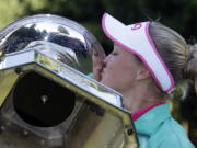 Brooke Henderson plants a kiss on the trophy Sunday after winning the Women&#039;s PGA Championship tournament at Sahalee Country Club in Sammamish.