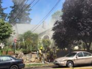 Firefighters work to extinguish a fire at 900 W. 16th St. in Vancouver on Saturday afternoon.