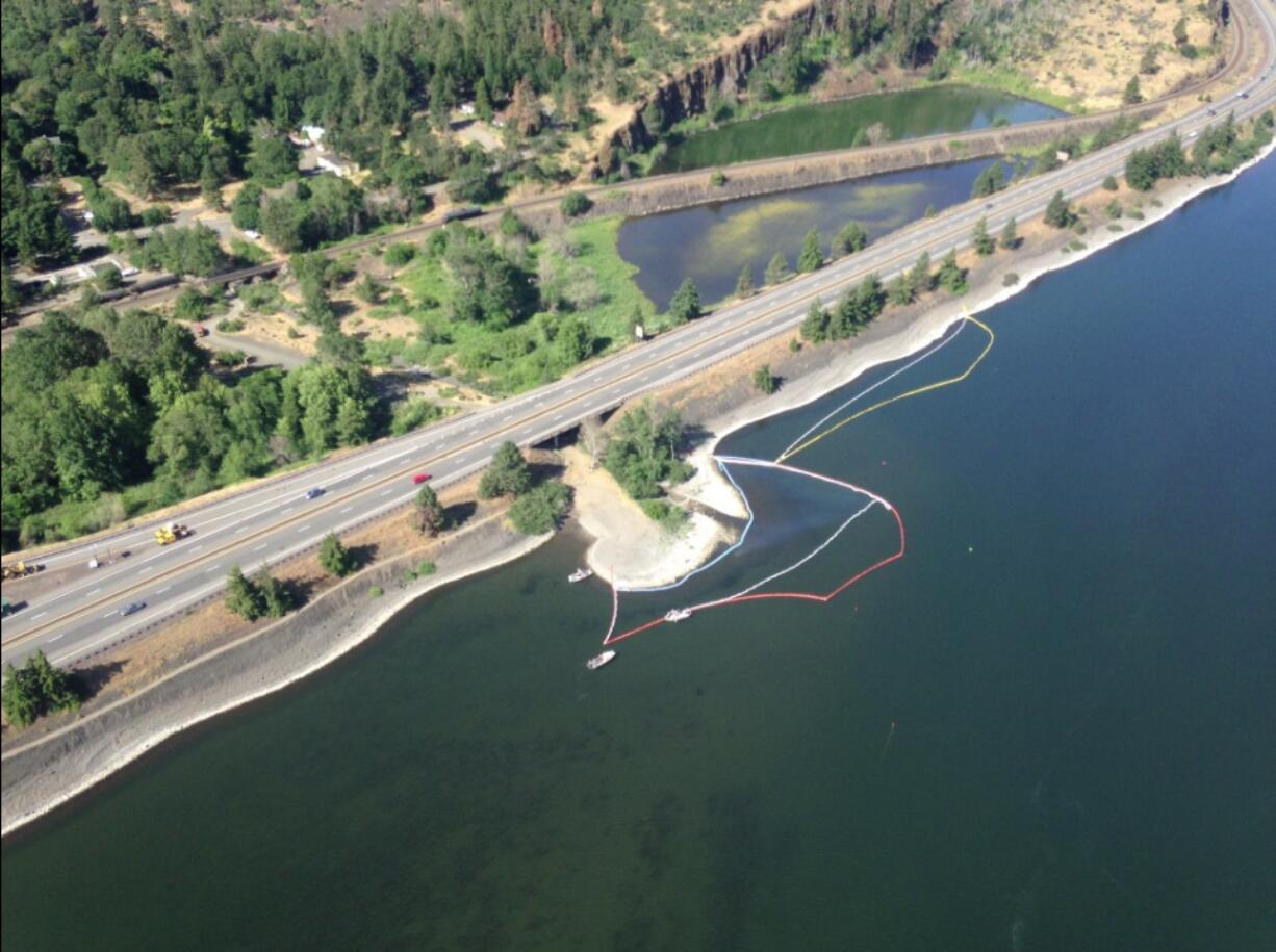 An image from a Washington Department of Ecology overflight shows efforts to boom in an oil sheen discovered near the site of Friday's oil train derailment, spill and fire near Mosier, Ore.