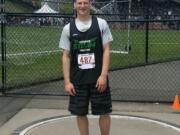 Trey Knight of Ridgefield stands at the shot put ring after setting a national record in Seattle.