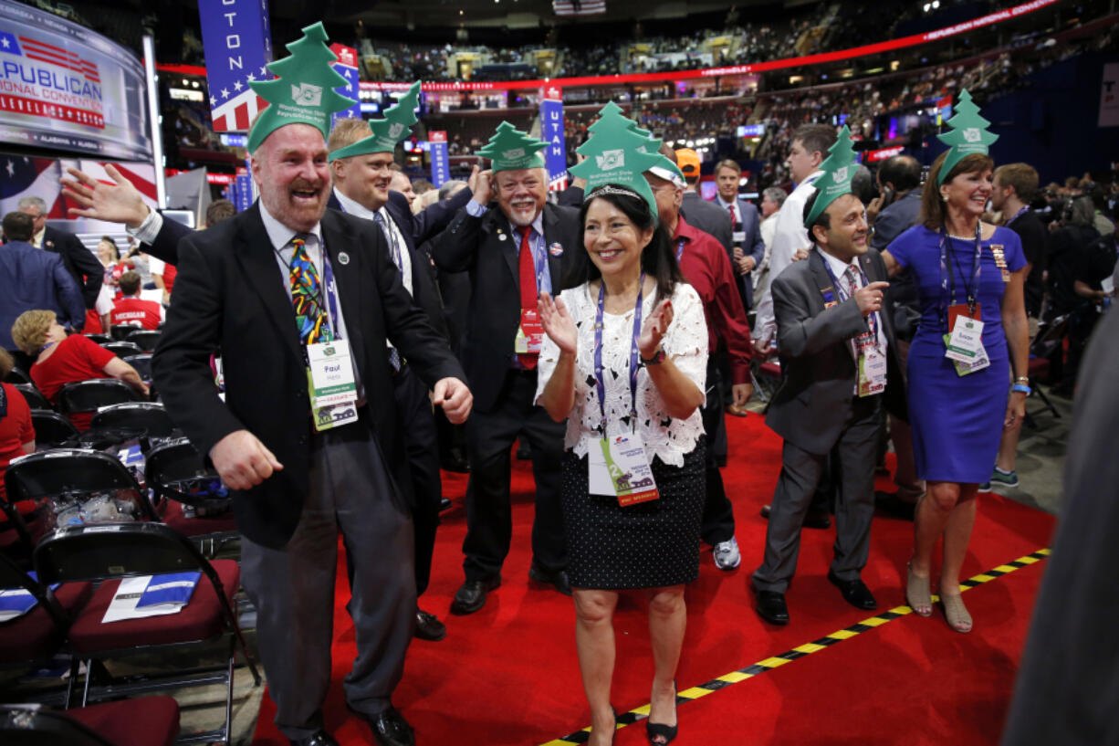 Washington delegates, along with state Sen. Don Benton, R-Vancouver, third from left, cheer Tuesday during the second day of the Republican National Convention in Cleveland.