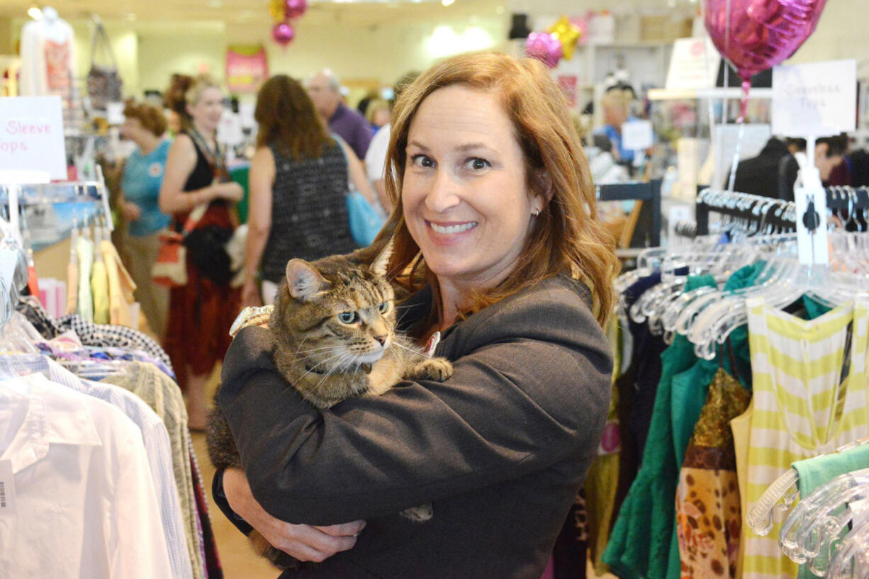 Nancy Lee with Dolly, whom she adopted from the Animal Rescue League. Dolly is the shop cat at WearWoof, Lee&#039;s upscale Ross, Pa., resale store, where all proceeds go to local animal shelters, and a presidential candidate.