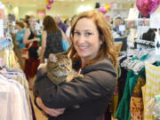 Nancy Lee with Dolly, whom she adopted from the Animal Rescue League. Dolly is the shop cat at WearWoof, Lee&#039;s upscale Ross, Pa., resale store, where all proceeds go to local animal shelters, and a presidential candidate.