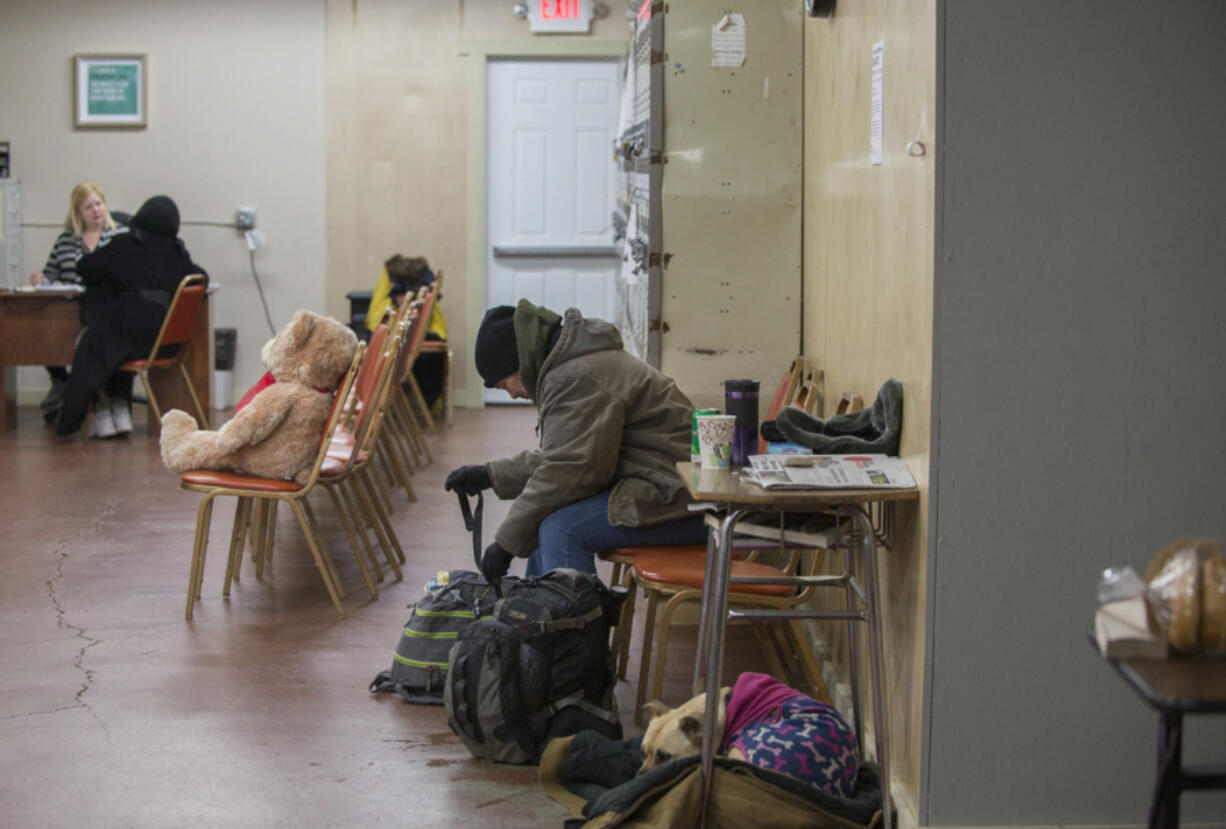 Heather Gallardo of Vancouver prepares to head back outside after getting dry and warm on a Wednesday afternoon in March at the Share day center in west Vancouver. The center had hoped to offer shower and laundry services but won&#039;t be able to at its current location.